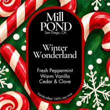Load image into Gallery viewer, “Holiday candle label with black background and red border, set against a green backdrop decorated with candy canes, snowflakes, and white snow‑like dots. Center text reads ‘Mill POND San Diego, CA’ and ‘Winter Wonderland’ with scent notes Fresh Peppermint, Warm Vanilla, and Cedar & Clove. Includes ‘handcrafted 100% soy wax’ at the bottom.”
