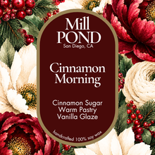 Load image into Gallery viewer, “Maroon candle label reading Cinnamon Morning, surrounded by red and white flowers, green leaves, and red berries.”
