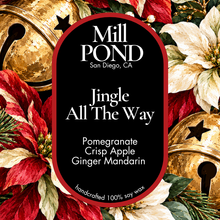 Load image into Gallery viewer, “Holiday candle label with black background, red border, gold jingle bells, and red-and-white poinsettias. Center text reads ‘Mill POND San Diego, CA’ and ‘Jingle All The Way’ with scent notes Pomegranate, Crisp Apple, and Ginger Mandarin. Includes ‘handcrafted 100% soy wax’ at the bottom.”
