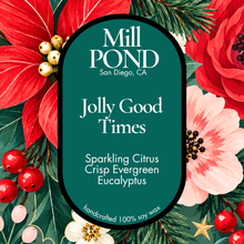 Load image into Gallery viewer, “Green candle label reading Jolly Good Times, surrounded by poinsettias, white flowers, evergreen branches, and red berries.”
