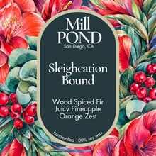 Load image into Gallery viewer, A square product label for Mill Pond Soaps 'Sleighcation Bound' handcrafted 100% soy wax. The label is dark charcoal gray with white text and a beige border, set against a vibrant watercolor background of red flowers, green leaves, and red berries.
