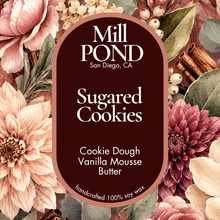 Load image into Gallery viewer, A decorative product label for Mill Pond Sugared Cookies, featuring white text on a dark burgundy central panel surrounded by illustrated flowers, leaves, cinnamon sticks, and berries. The label reads: Mill POND, San Diego, CA, Sugared Cookies, Cookie Dough, Vanilla Mousse Butter, and handcrafted 100% soy wax.
