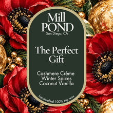 Load image into Gallery viewer, “Green candle label reading The Perfect Gift, surrounded by red flowers, green leaves, and gold ornaments.”
