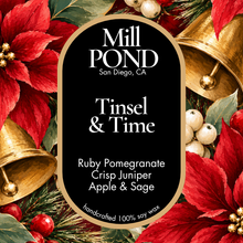Load image into Gallery viewer, A square product label for Mill Pond Tinsel &amp; Time soy wax candle, featuring a black background with white text and a gold border, surrounded by festive red poinsettias, green pine needles, white berries, and gold bells.
